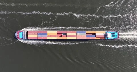 Aerial drone video of a top down view on an inland container ship sailing. Stock Footage 245307536
