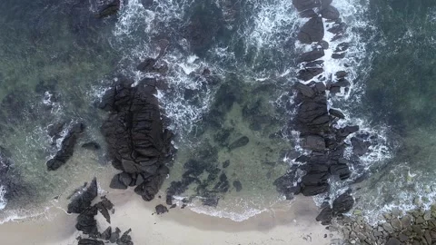 Aerial drone video of waves breaking against the rocks on the shore Stock-Footage 201197988