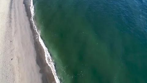 Aerial drone video of the waves breaking on a beach Stock-Footage 247485328