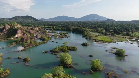 Aerial drone view of abandoned quarry lake with small vegetated islands Stock Footage 337724337