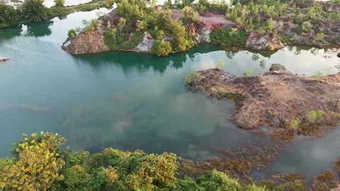Aerial drone view of abandoned quarry lake and rocky islands Video stock 337983185