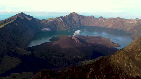 Aerial drone view of active Rinjani volcano during sunrise on the island of Stock Footage 303979144