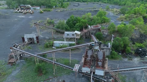 Aerial drone view of aggregate crushing plant and conveyor belts and quarry. Video stock 337795495