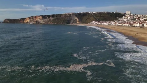 Aerial drone view alongside the coastline of Nazare, Portugal Stock Footage 287710066