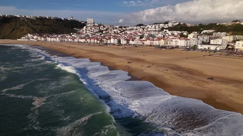 Aerial drone view alongside the coastline of Nazare, Portugal Stock Footage 287710125