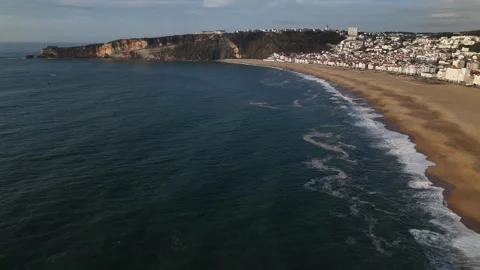 Aerial drone view alongside the coastline of Nazare, Portugal Stock Footage 287710846