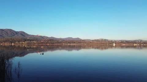 Aerial Drone View of Alpine Lake with Golden Reflections Stock-Footage 323217196