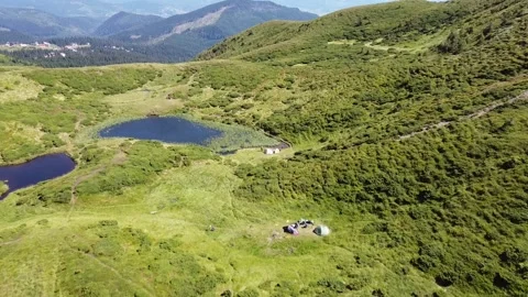 Aerial drone view of alpine lakes among green mountain meadows Stock Footage 338104599