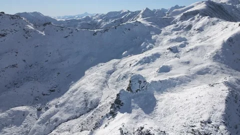 Aerial drone view of the alps under the blue sky on a cold winter day Stock Footage 215874318