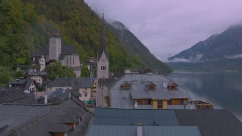 Aerial drone view approaching hallstatt church and alpine village in austria Stock Footage 342141251