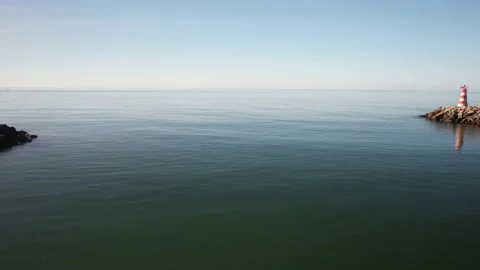 Aerial drone view approaching Vilamoura Lighthouse at the entrance of the marina Stock Footage 239462858