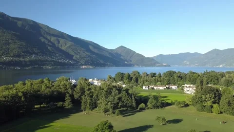 Aerial drone view of Ascona and Lake Maggiore in summer with blue sky and m.. Video stock 323606645