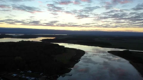 Aerial drone view away from sunlit archipelago islands, during a colorful Stock Footage 195656294