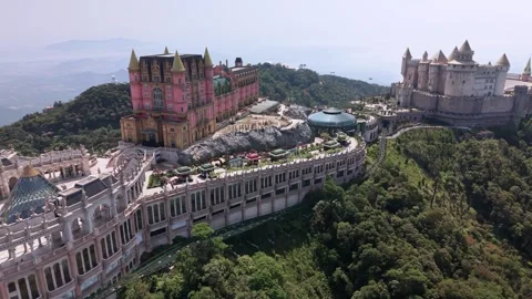 Aerial drone view of Ba Na Hills SunWorld complex with castle and forest in Stock Footage 340029896