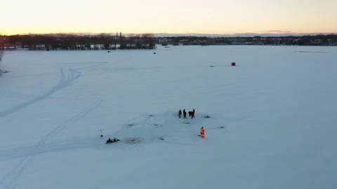 Aerial drone view backing from a group of ice fishing men revealing other fis Stock-Footage 163981107