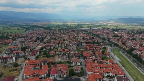 Aerial drone view of Bansko town and red roofs in Bulgaria Stock Footage 343644192