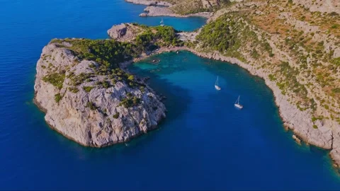 Aerial drone view of bay and lagoon on island with blue water and rock cliff Stock Footage 341825282