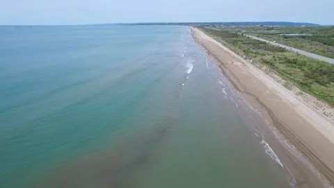 Aerial drone view of the beach and car Stock Footage 242395643