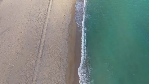 Aerial drone view of beach waves and clear turquoise sea Stock Footage 320911695