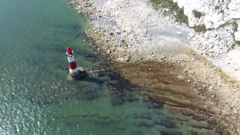 Aerial drone View of Beachy Head Lighthouse beside chalk cliff and clear Stock Footage 342296499