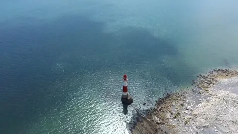 Aerial drone View of Beachy Head Lighthouse beside chalk cliff and blue coastal Stock Footage 342296501