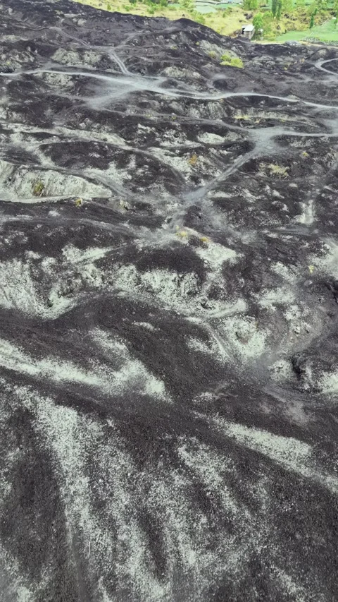 Aerial drone view of black lava field and volcanic terrain landscape Stock Footage 346942168