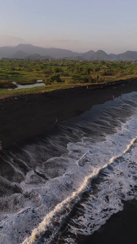 Aerial Drone View of Black Sand Beach and Green Coastline, East Bali, Indonesia Video stock 337229429