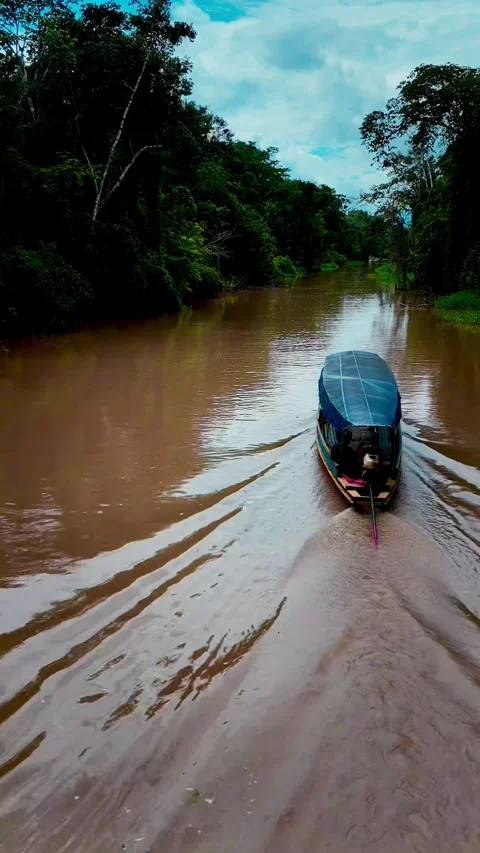 Aerial drone view of boat navigating tropical river 動画素材 316402424
