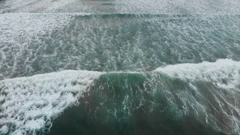 Aerial drone view of breaking ocean waves in California Stock Footage 330950695