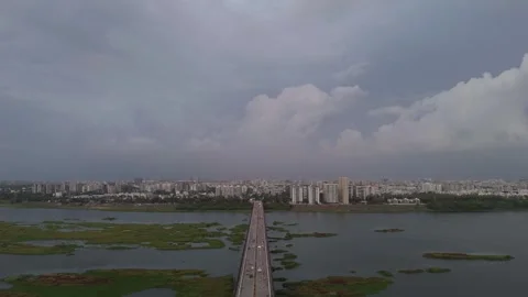 Aerial Drone View of Bridge Crossing River with Dramatic Monsoon Clouds Stock-Footage 338351744