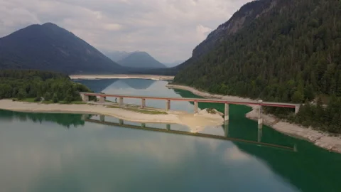 Aerial Drone View of Bridge Crossing Emerald Mountain Reservoir in Tyrol Austria Stock Footage 340488365