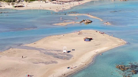 Aerial drone view of a broad sandy spit and shallow turquoise lagoon with Stock Footage 339301350