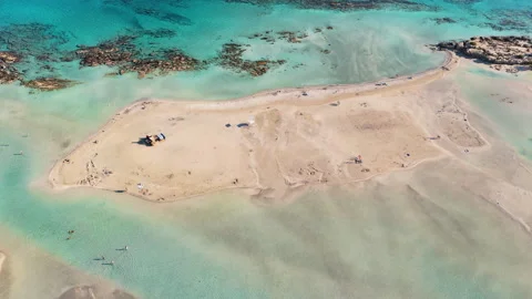 Aerial drone view of a broad sandy spit reaching into a clear turquoise lagoon Stock Footage 339301867