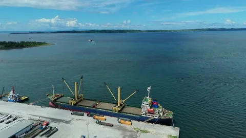 Aerial drone view of bulk cargo ship docked at commercial port terminal Stock Footage 337847122