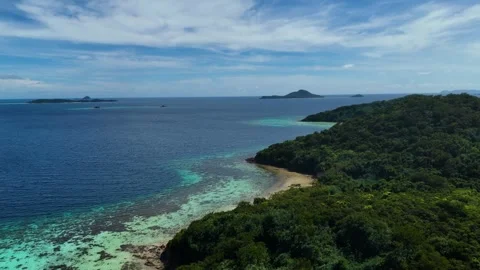 Aerial drone view of Bulog Dos Island, showcasing its pristine white sand beach Stock Footage 295913232