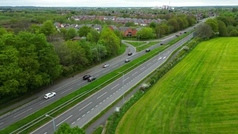 Aerial Drone View of Busy Multi‑Lane Highway with Cars and Green Landscape Stock Footage 333630941