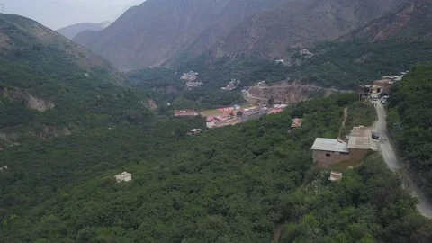 Aerial drone view of a cable car moving through mountains and green trees in the 動画素材 198776179
