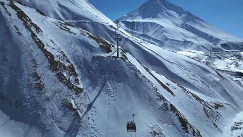 Aerial Drone View of a Cable Car System Moving Through Snow-Covered Mountains  Stock Footage 305397281