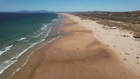 Aerial drone view at Caparica Beach in Almada District, Greater Lisbon, Portugal Stock Footage 207422154