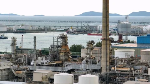 Aerial drone view captures a coastal oil refinery with storage tanks. Stock Footage 337711315