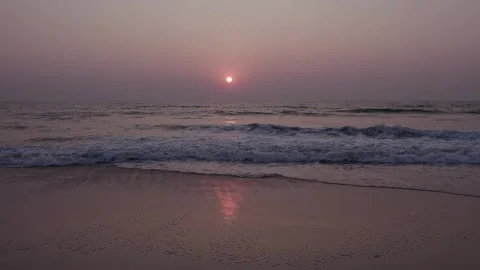 Aerial drone view capturing a breathtaking sunset over the calm waves of th.. Stock Footage 340967090