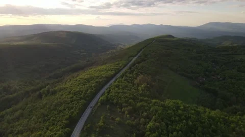 Aerial Drone View Car Driving on Curvy Mountain asphalt Road in Spring Stock Footage 240503347