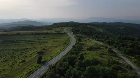 Aerial Drone View Car Driving on Curvy Mountain asphalt Road in summer Stock Footage 244493415