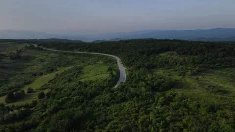 Aerial Drone View Car Driving on Curvy Mountain asphalt Road in summer Stock Footage 244493424