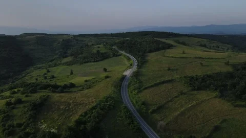 Aerial Drone View Car Driving on Curvy Mountain asphalt Road in summer Stock Footage 244493437