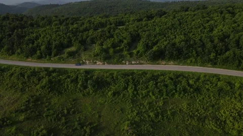 Aerial Drone View Car Driving on Curvy Mountain asphalt Road in summer Stock Footage 244493579