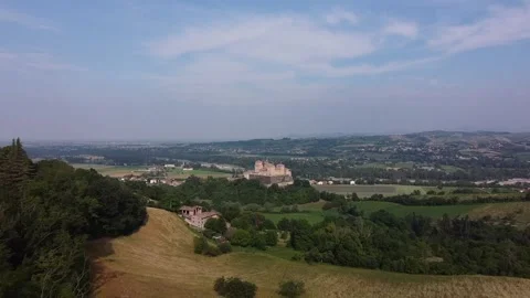 Aerial drone view of castle called Castello di Torrechiara between tree branches Stock Footage 247836872