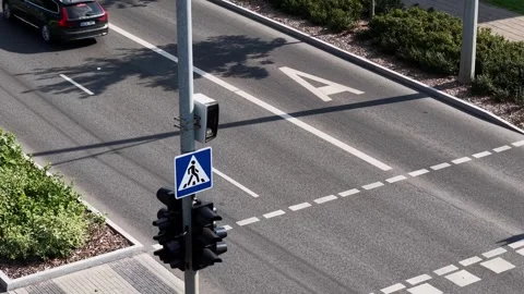 Aerial drone view of a city intersection with traffic lights and a pedestrian Stock Footage 327488601