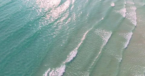 Aerial drone view of clear turquoise sea and waves over the beach Stock-Footage 239714564