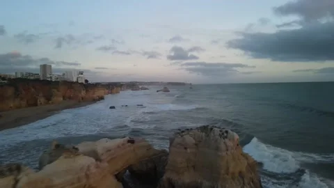 Aerial drone view of cliffs and beaches in Portimao during the sunset Stock Footage 167923444